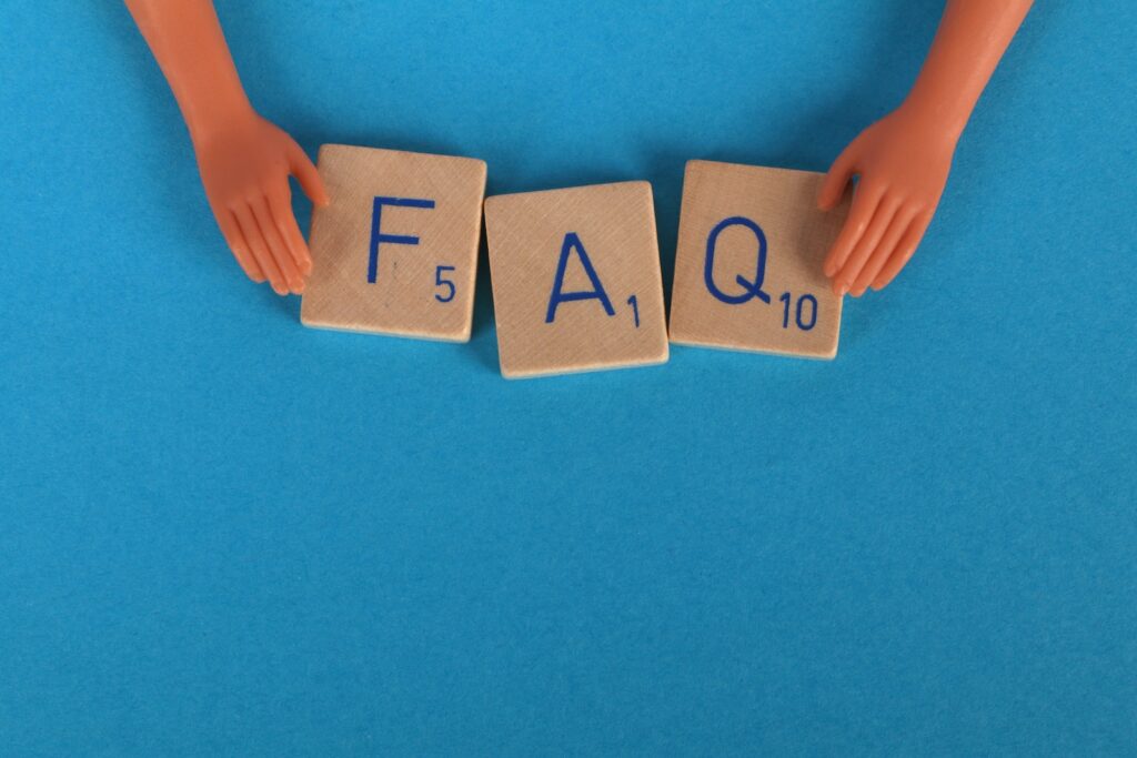 Close-Up Shot of Scrabble Tiles on a Blue Surface